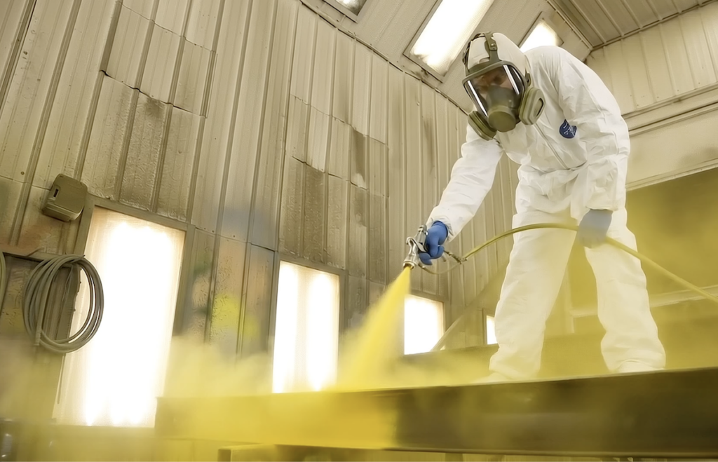 Worker spray painting equipment